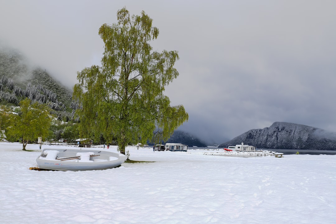 a boat sitting on top of a snow covered field
